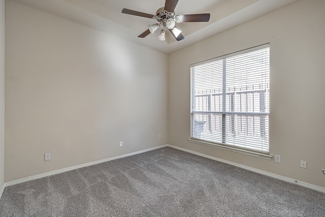 carpeted spare room with ceiling fan