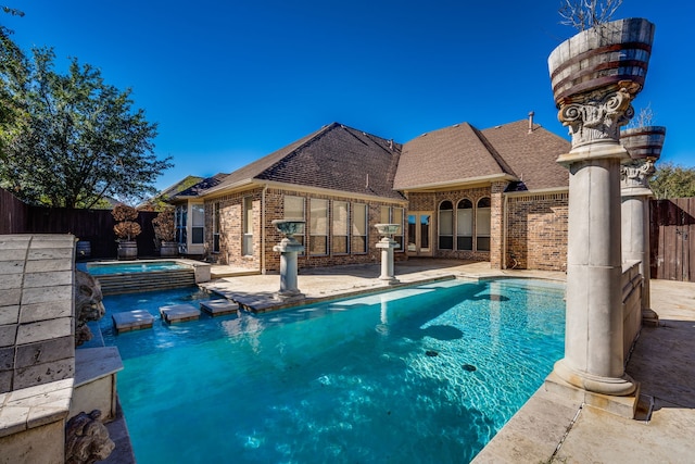 view of swimming pool with a patio and an in ground hot tub