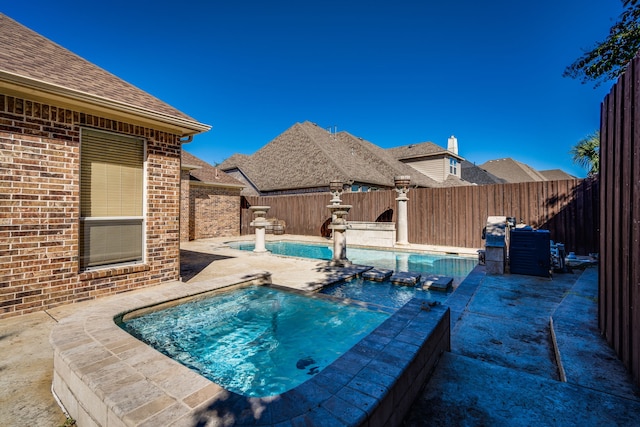 view of pool featuring an in ground hot tub and a patio area