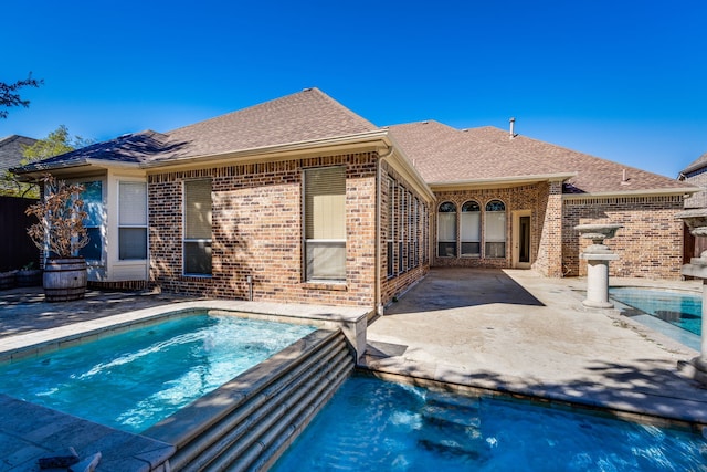 view of swimming pool with a patio and a jacuzzi