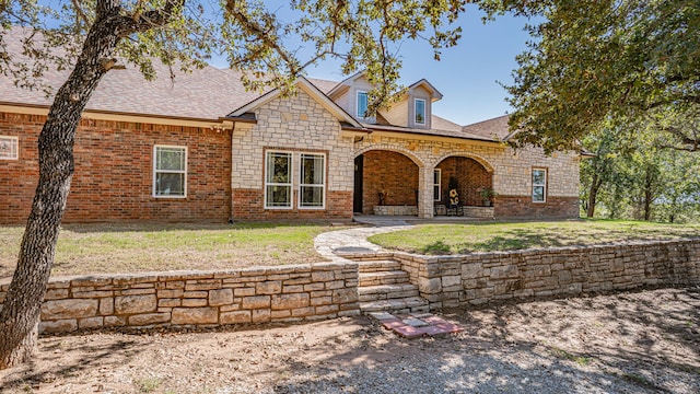 view of front of house with a front lawn and a patio