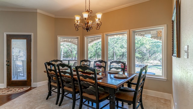 dining space featuring a wealth of natural light, a chandelier, and ornamental molding