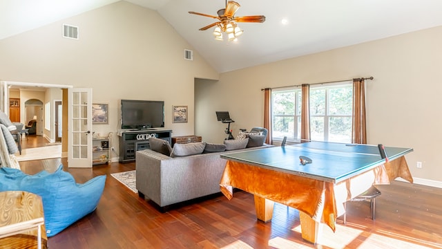 playroom with dark wood-type flooring, ceiling fan, french doors, and high vaulted ceiling