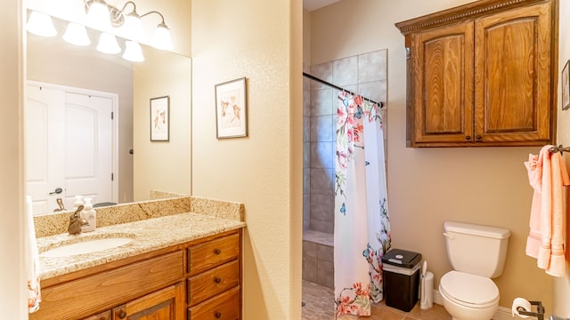 bathroom with walk in shower, vanity, toilet, and tile patterned floors