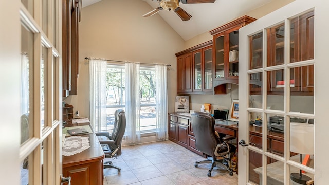 tiled office space with ceiling fan and high vaulted ceiling