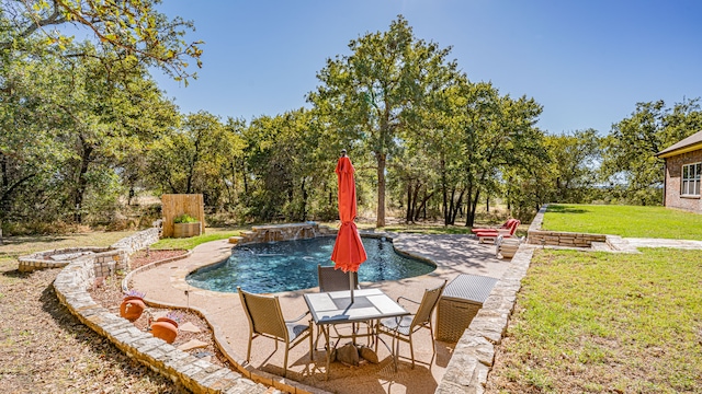 view of swimming pool featuring pool water feature, a patio, and a yard