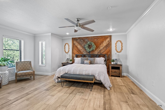 bedroom with ceiling fan, light wood-type flooring, and crown molding