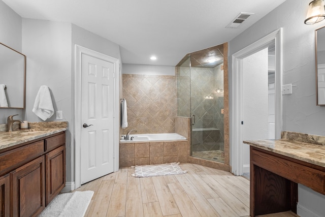 bathroom with vanity, shower with separate bathtub, and hardwood / wood-style flooring