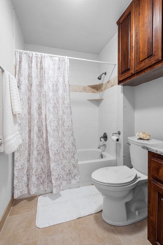 full bathroom featuring vanity, a textured ceiling, shower / tub combo, tile patterned flooring, and toilet