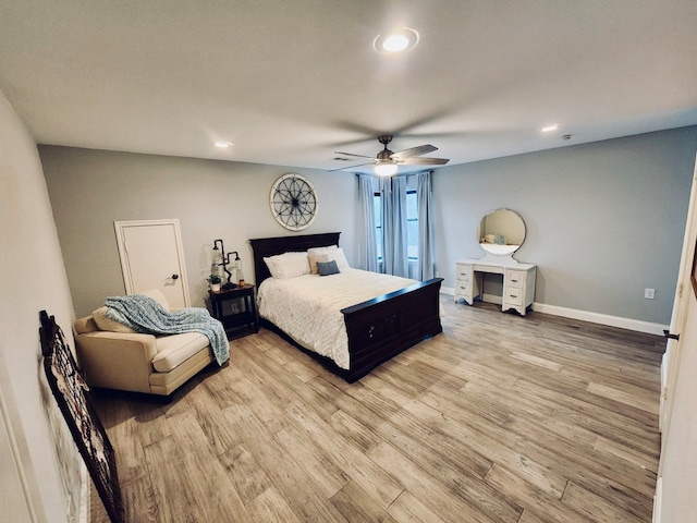 bedroom with light hardwood / wood-style floors and ceiling fan