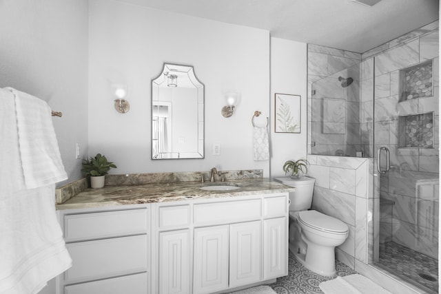 bathroom featuring vanity, toilet, and an enclosed shower