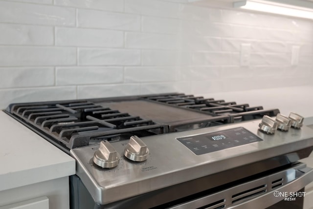 interior details with decorative backsplash and stainless steel range