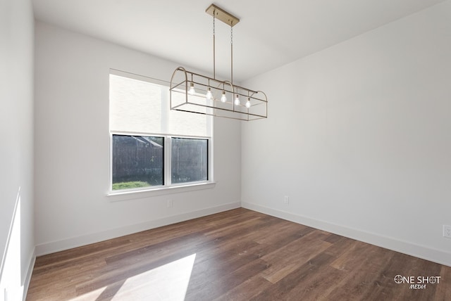 7813 Langford Dr, Abilene, TX 79606 - unfurnished dining area featuring wood finished floors, baseboards, and a chandelier