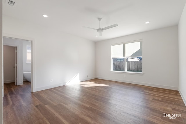 spare room with ceiling fan and dark wood-type flooring