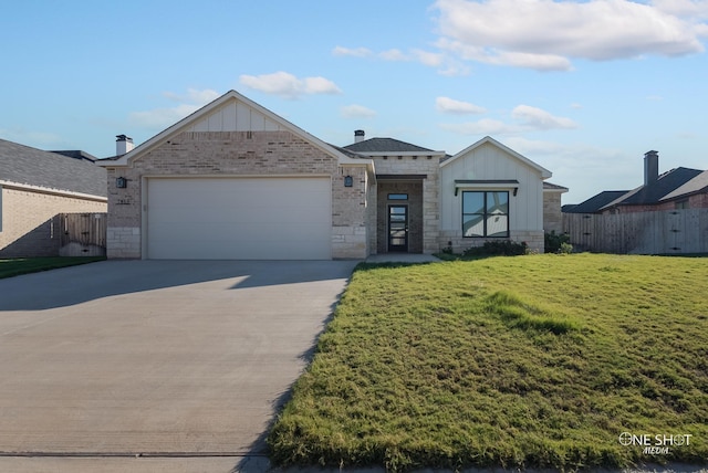 view of front of home featuring a garage and a front lawn