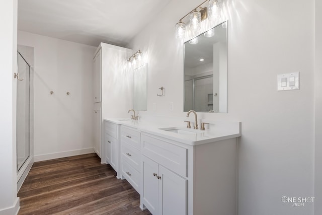 bathroom featuring a shower with door, vanity, and hardwood / wood-style flooring