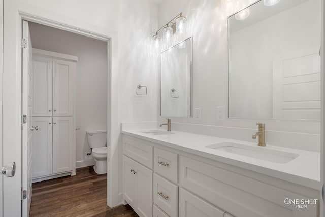 bathroom featuring hardwood / wood-style flooring, vanity, and toilet