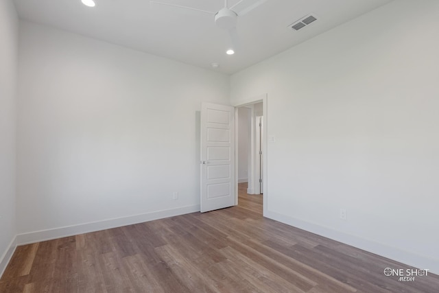 spare room with ceiling fan and light wood-type flooring