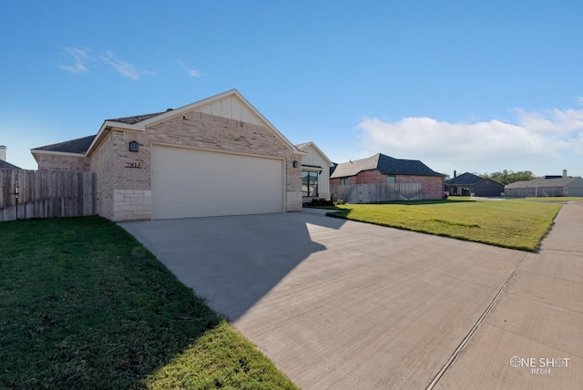 ranch-style house featuring a garage and a front lawn