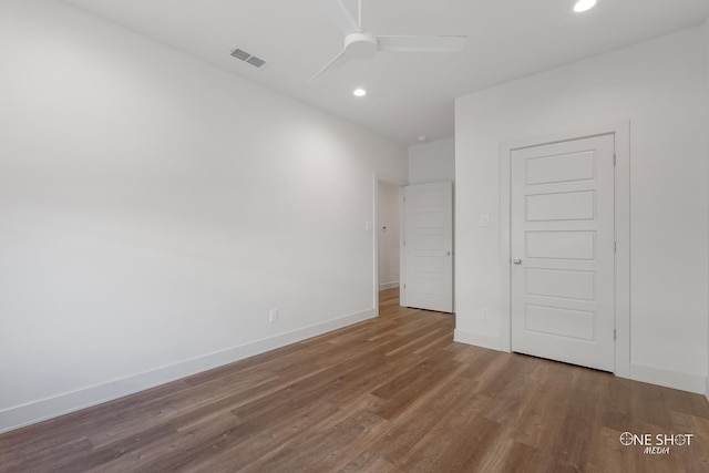 unfurnished bedroom with hardwood / wood-style floors, a closet, and ceiling fan