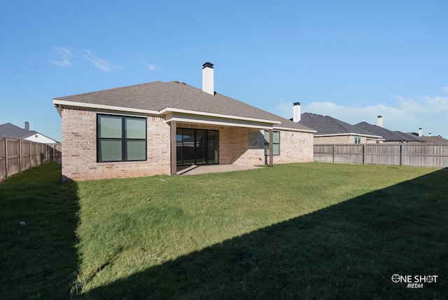 rear view of property with a yard