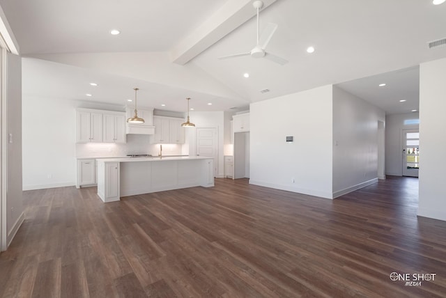 unfurnished living room with lofted ceiling with beams, ceiling fan, sink, and dark wood-type flooring