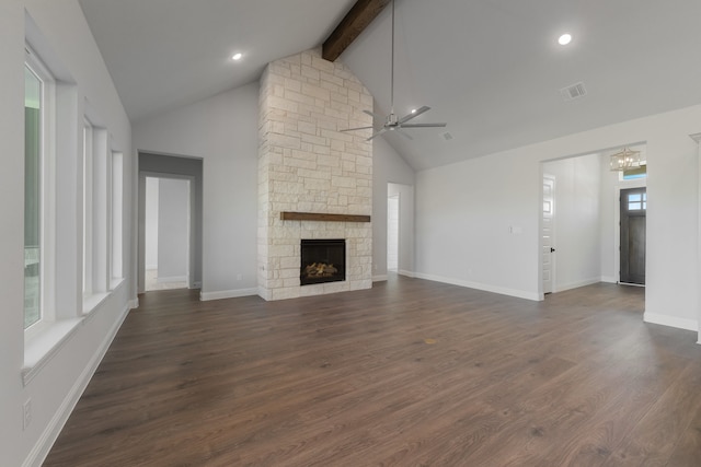 unfurnished living room with beam ceiling, high vaulted ceiling, plenty of natural light, and dark wood-type flooring