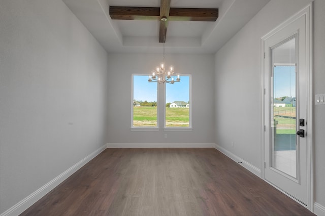 spare room with beamed ceiling, dark hardwood / wood-style floors, a tray ceiling, and a notable chandelier