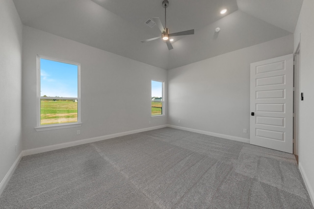 carpeted spare room featuring ceiling fan and lofted ceiling