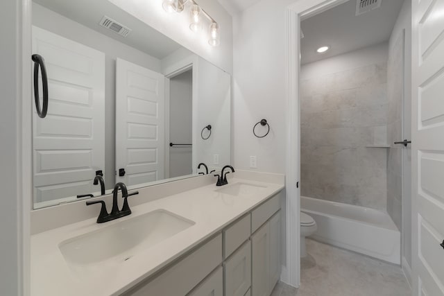 full bathroom with vanity, toilet, and tiled shower / bath combo