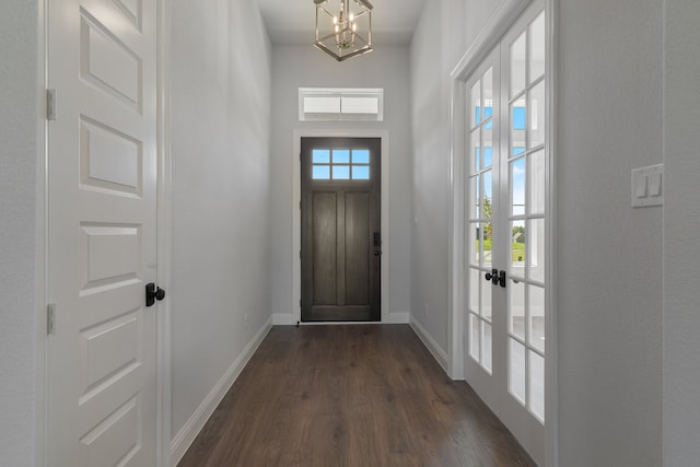 doorway to outside featuring french doors, dark hardwood / wood-style flooring, and an inviting chandelier