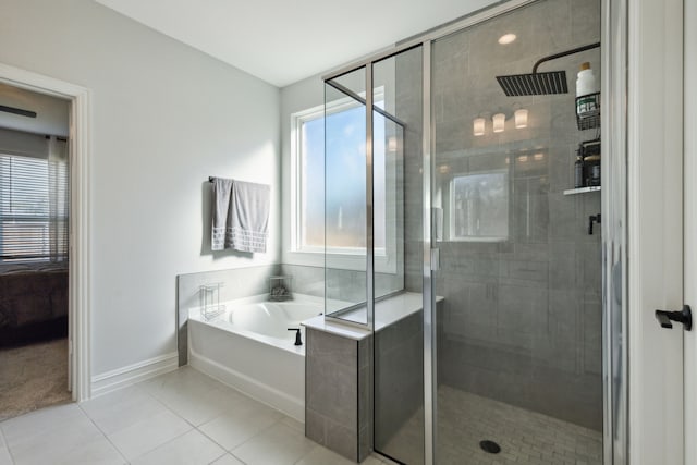 bathroom featuring tile patterned floors, plus walk in shower, and a healthy amount of sunlight