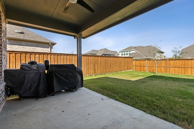 view of yard featuring ceiling fan and a patio area