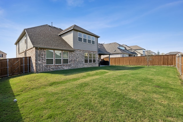 back of house featuring a lawn