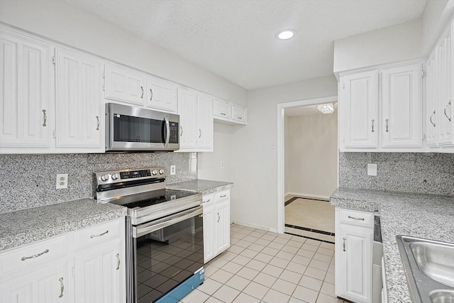 kitchen with light countertops, backsplash, and stainless steel appliances