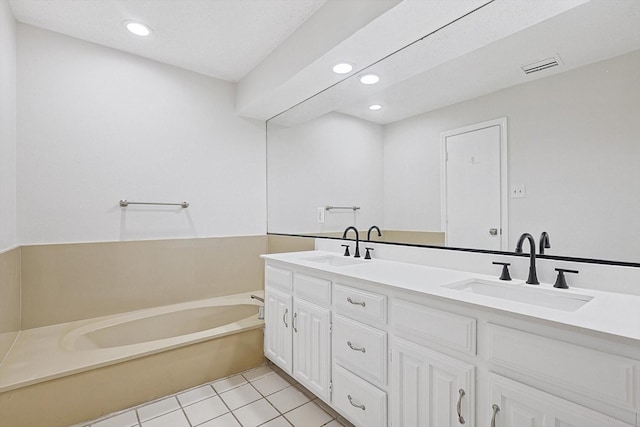 full bathroom featuring double vanity, recessed lighting, a sink, tile patterned floors, and a bath