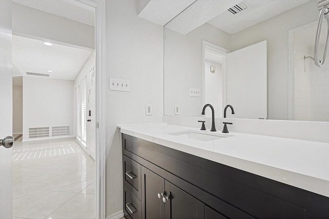 full bath with tile patterned floors, visible vents, a shower, and vanity