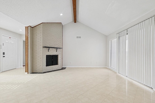 unfurnished living room with visible vents, lofted ceiling with beams, a textured ceiling, light tile patterned floors, and baseboards