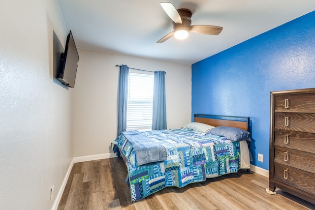 bedroom with hardwood / wood-style flooring and ceiling fan