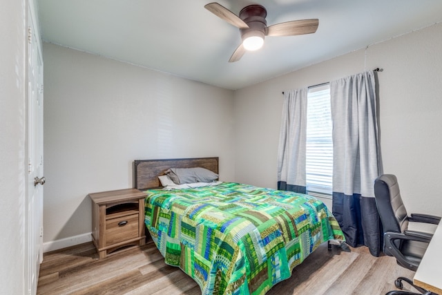 bedroom featuring light hardwood / wood-style flooring and ceiling fan