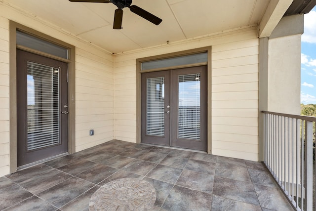 view of exterior entry featuring ceiling fan and a patio