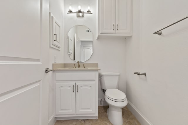 bathroom featuring tile patterned flooring, vanity, and toilet