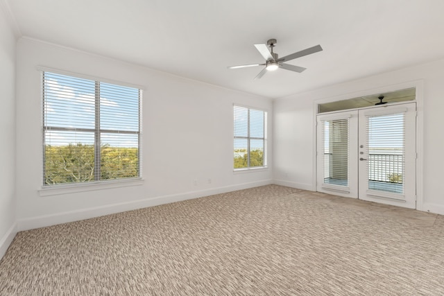 spare room with ceiling fan, plenty of natural light, french doors, and ornamental molding