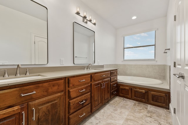 bathroom with a washtub and vanity