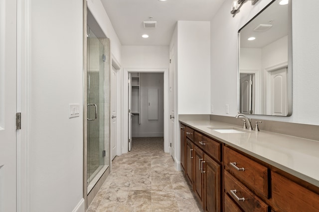 bathroom with walk in shower and vanity