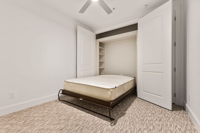 carpeted bedroom featuring ceiling fan and a closet