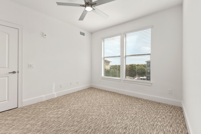 unfurnished room featuring light carpet and ceiling fan