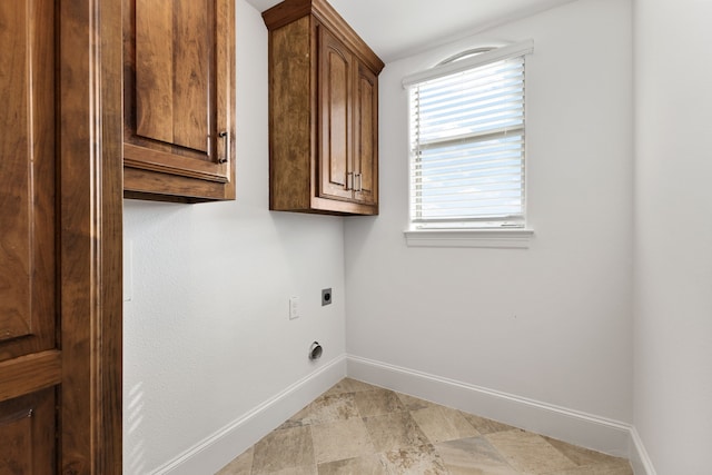 laundry room with hookup for an electric dryer and cabinets