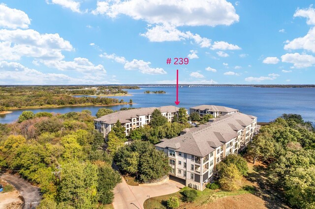 birds eye view of property with a water view