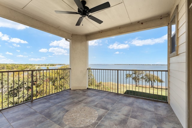 balcony featuring a water view and ceiling fan